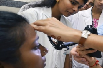 A doctor examines a patient's eye